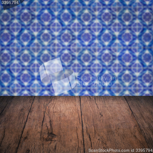 Image of Wood table top and blur vintage ceramic tile pattern wall