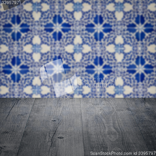 Image of Wood table top and blur vintage ceramic tile pattern wall