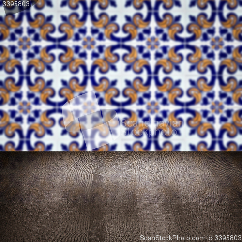 Image of Wood table top and blur vintage ceramic tile pattern wall