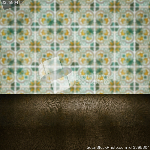 Image of Wood table top and blur vintage ceramic tile pattern wall