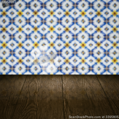 Image of Wood table top and blur vintage ceramic tile pattern wall