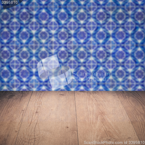 Image of Wood table top and blur vintage ceramic tile pattern wall