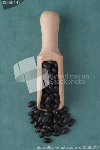 Image of Wooden scoop with black beans