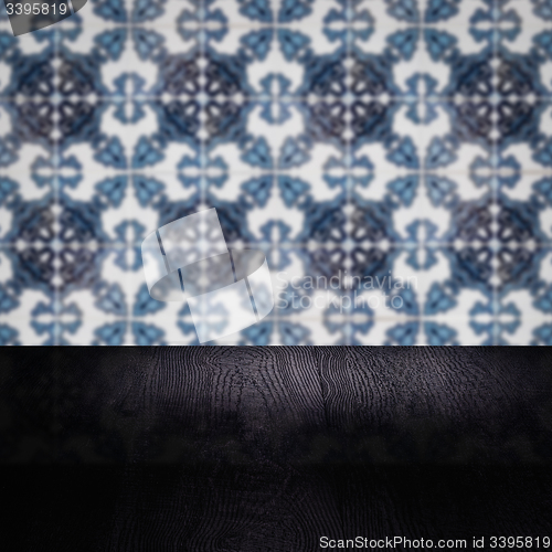 Image of Wood table top and blur vintage ceramic tile pattern wall