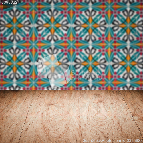 Image of Wood table top and blur vintage ceramic tile pattern wall