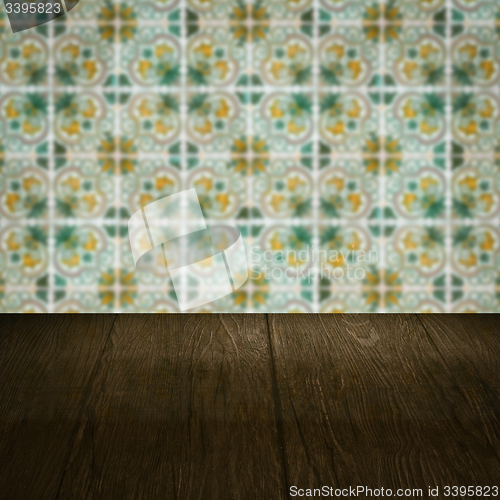 Image of Wood table top and blur vintage ceramic tile pattern wall