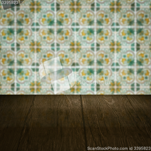 Image of Wood table top and blur vintage ceramic tile pattern wall