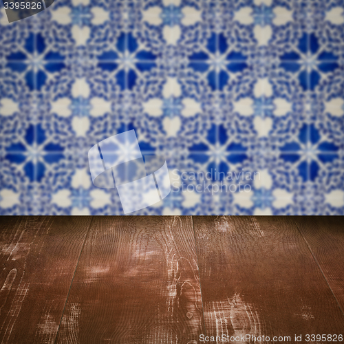 Image of Wood table top and blur vintage ceramic tile pattern wall