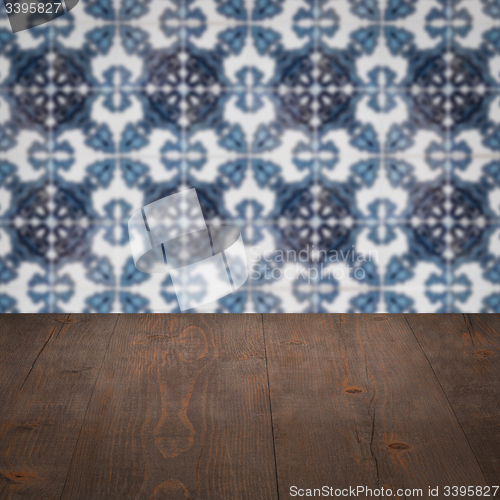 Image of Wood table top and blur vintage ceramic tile pattern wall