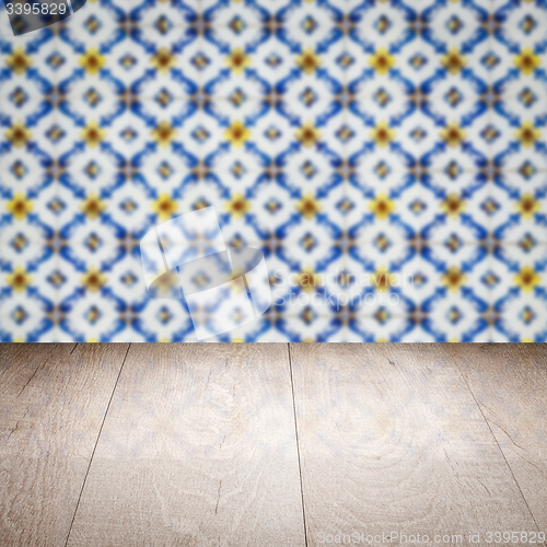 Image of Wood table top and blur vintage ceramic tile pattern wall
