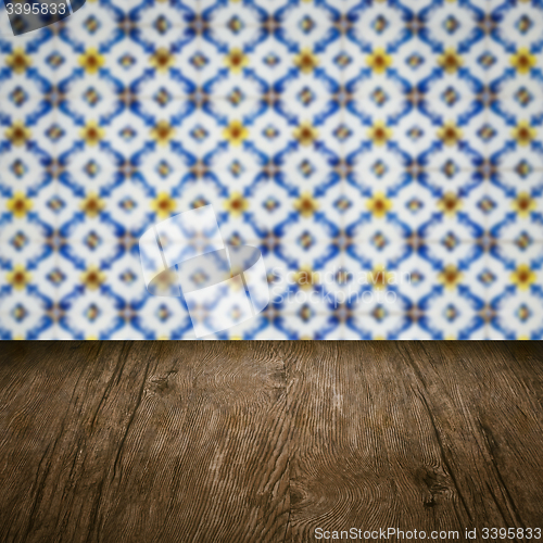 Image of Wood table top and blur vintage ceramic tile pattern wall
