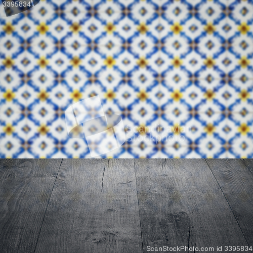 Image of Wood table top and blur vintage ceramic tile pattern wall