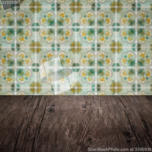 Image of Wood table top and blur vintage ceramic tile pattern wall