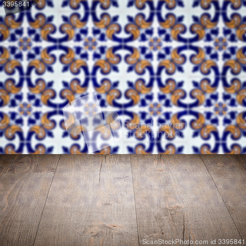 Image of Wood table top and blur vintage ceramic tile pattern wall
