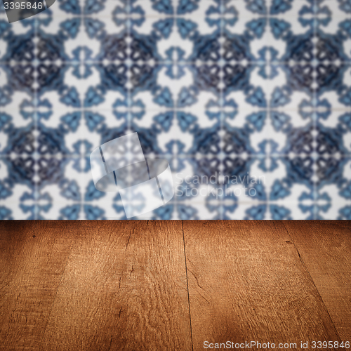 Image of Wood table top and blur vintage ceramic tile pattern wall