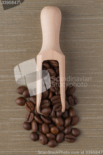 Image of Wooden scoop with coffee beans