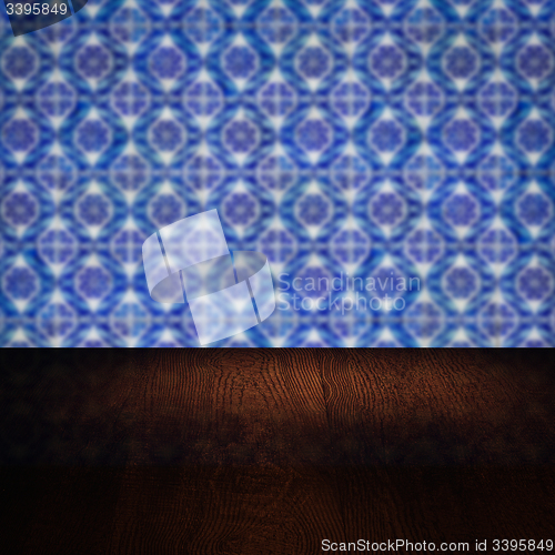 Image of Wood table top and blur vintage ceramic tile pattern wall