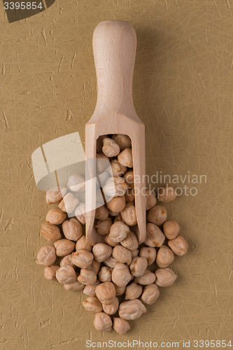 Image of Wooden scoop with chickpeas