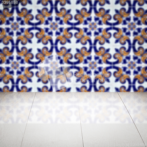 Image of Wood table top and blur vintage ceramic tile pattern wall