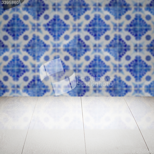 Image of Wood table top and blur vintage ceramic tile pattern wall