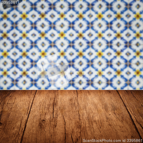 Image of Wood table top and blur vintage ceramic tile pattern wall