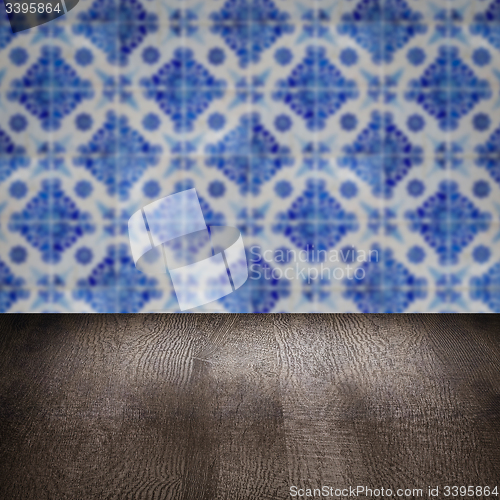 Image of Wood table top and blur vintage ceramic tile pattern wall