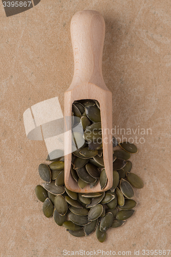 Image of Wooden scoop with pumpkin seeds