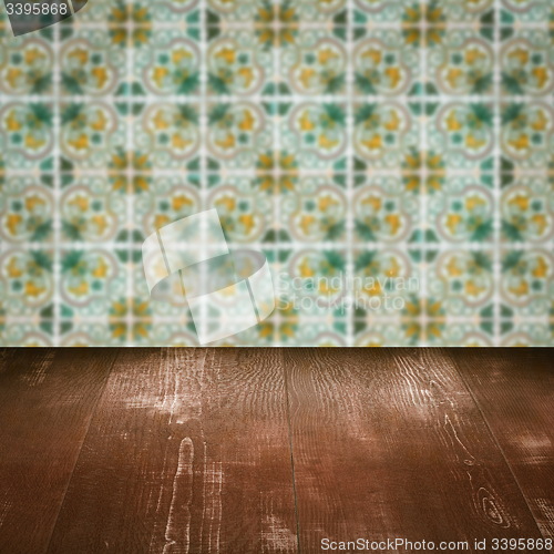 Image of Wood table top and blur vintage ceramic tile pattern wall