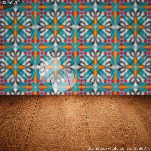 Image of Wood table top and blur vintage ceramic tile pattern wall