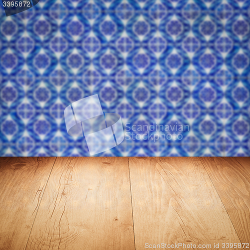 Image of Wood table top and blur vintage ceramic tile pattern wall