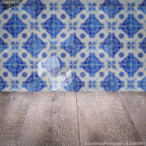 Image of Wood table top and blur vintage ceramic tile pattern wall