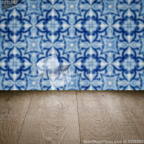 Image of Wood table top and blur vintage ceramic tile pattern wall