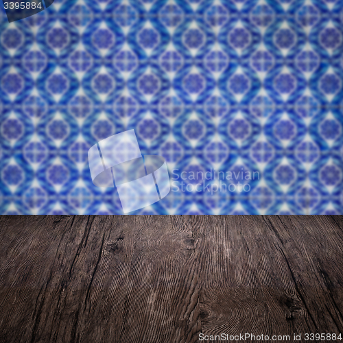 Image of Wood table top and blur vintage ceramic tile pattern wall