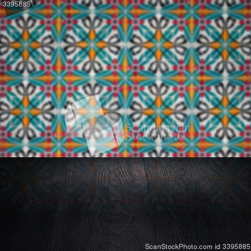 Image of Wood table top and blur vintage ceramic tile pattern wall