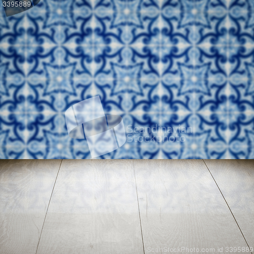 Image of Wood table top and blur vintage ceramic tile pattern wall