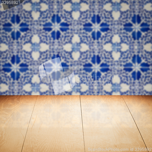 Image of Wood table top and blur vintage ceramic tile pattern wall