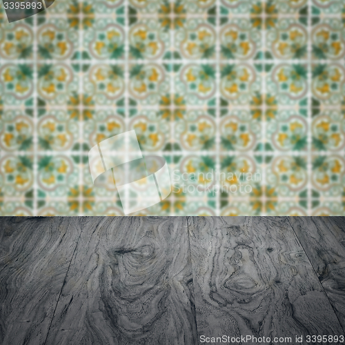Image of Wood table top and blur vintage ceramic tile pattern wall