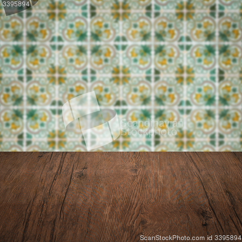 Image of Wood table top and blur vintage ceramic tile pattern wall