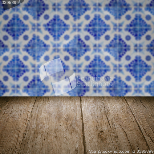 Image of Wood table top and blur vintage ceramic tile pattern wall