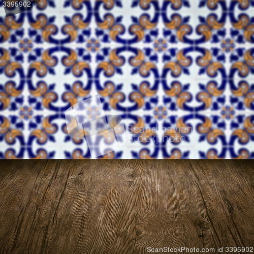 Image of Wood table top and blur vintage ceramic tile pattern wall