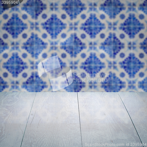 Image of Wood table top and blur vintage ceramic tile pattern wall