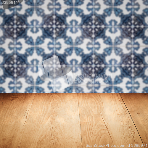 Image of Wood table top and blur vintage ceramic tile pattern wall