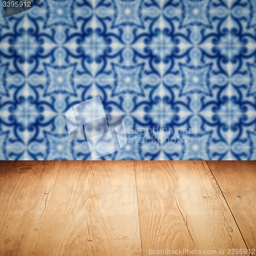 Image of Wood table top and blur vintage ceramic tile pattern wall