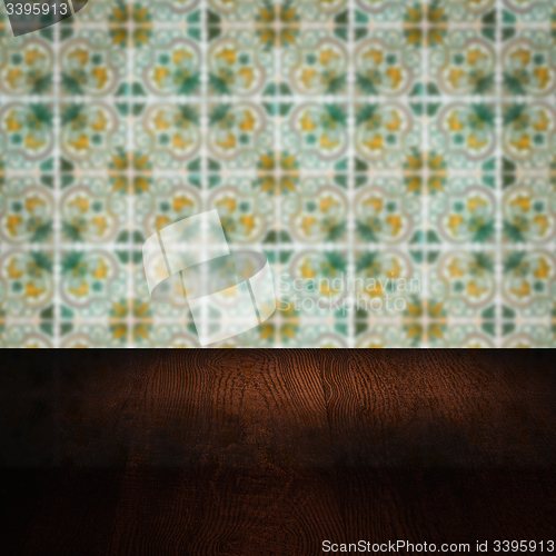 Image of Wood table top and blur vintage ceramic tile pattern wall