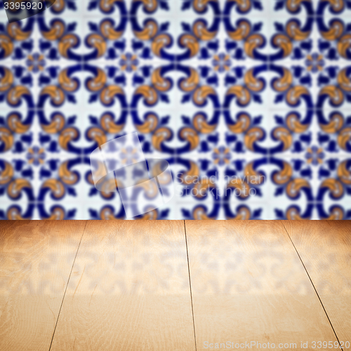 Image of Wood table top and blur vintage ceramic tile pattern wall