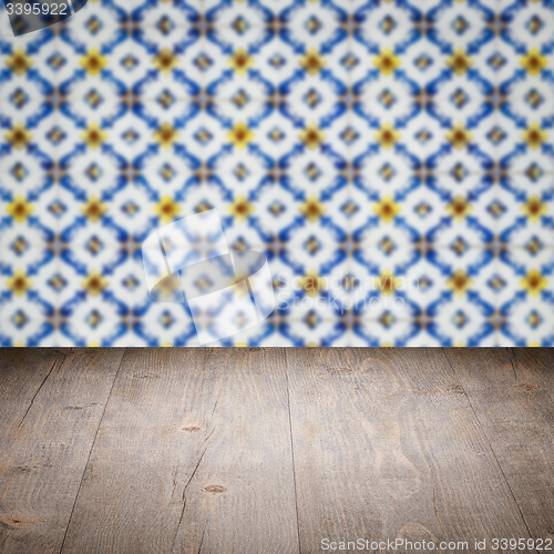 Image of Wood table top and blur vintage ceramic tile pattern wall