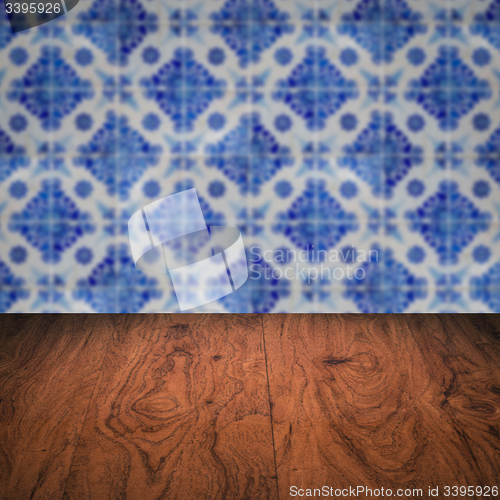 Image of Wood table top and blur vintage ceramic tile pattern wall