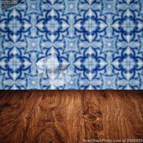 Image of Wood table top and blur vintage ceramic tile pattern wall