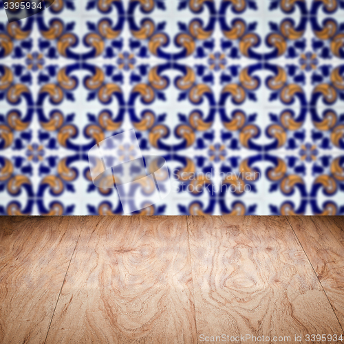 Image of Wood table top and blur vintage ceramic tile pattern wall