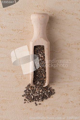 Image of Wooden scoop with chia seeds